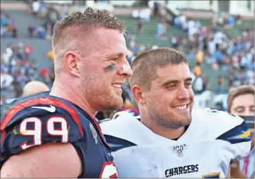  ?? AP - John Cordes, File ?? Texans defensive end J.J. Watt (99) stands next to his brother, Derek, then a fullback for the Chargers after a game last year. The three Watt brothers will share the field for the first time as profession­als on Sunday when J.J. and the Texans visit T.J., Derek and the Steelers.