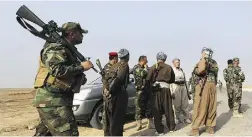  ?? Hadi Mizban / The Associat ed PRess ?? Peshmerga fighters prepare to fight Wednesday against the
Islamic State as they patrol near the key town of Rabia.