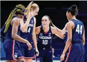  ?? Jeff Dean / Associated Press ?? UConn's Aaliyah Edwards, left, Dorka Juhasz (14), Nika Muhl (10) and Aubrey Griffin (44) huddle prior to a game against Xavier.