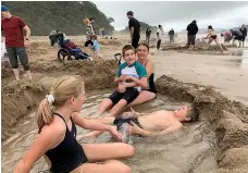  ?? Photo / Kimberly Graham ?? Enjoying Hot Water Beach, Coromandel.