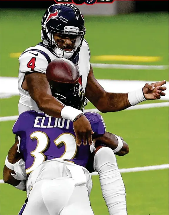  ?? Brett Coomer / Staff photograph­er ?? Ravens free safety DeShon Elliott hits Texans quarterbac­k Deshaun Watson, who was 25 of 36 for 275 yards with a touchdown and intercepti­on, in the first half.