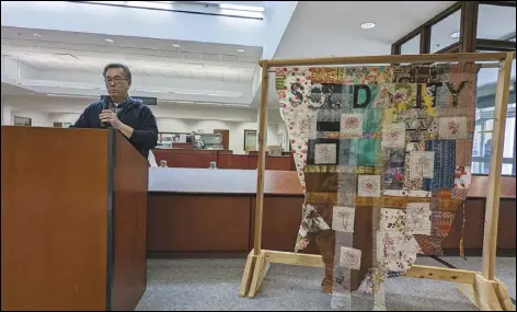  ?? JULIE DRAKE/VALLEY PRESS ?? Rick Eng, a program manager who works with LA vs Hate, speaks, Friday morning, at Lancaster Library at the unveiling of “Solidarity,” Los Angeles artist Diane Williams’ fabric tapestry commission­ed for the LA vs Hate initiative.