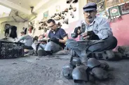  ??  ?? The Çancı family crafts bells in their workshop, in Manisa, Turkey, June 30, 2020.