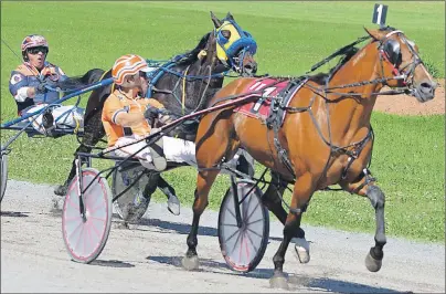  ?? JASON SIMMONDS/JOURNAL PIONEER ?? Kenny Murphy drives Machinthes­and to a 1:57.2 victory in the featured race at Red Shores at Summerside Raceway on Sunday afternoon. The Walter Cheverie-driven D Bs Rosco, also in the photo, finished third in the $2,400 event.