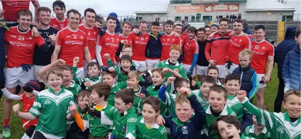  ??  ?? Young Geraldines GFC players join Louth players to celebrate following their National League Division Three win over Offaly in Tullamore’s O’Connor Park.