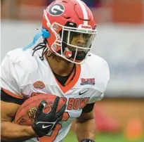  ?? BUTCH DILL/AP ?? American running back Kenny McIntosh of Georgia runs through drills during practice for the Senior Bowl on Thursday in Mobile, Ala.