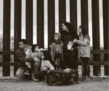  ?? Tamir Kalifa / New York Times file photo ?? A Honduran family seeking asylum waits to be taken into custody in 2019 by Border Patrol officers in Penitas, along the border in Hidalgo County. DACA, TPS and the wall are some of the issues immediatel­y facing President-elect Joe Biden.