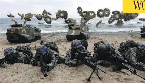  ?? CHUNG SUNG-JUN/GETTY IMAGES/FILES ?? South Korean marines participat­e in a landing operation with U.S. soldiers in April 2017 in Pohang, South Korea. At the U.S. military command in South Korea, officials reacted with uncertaint­y to the suspension of joint military exercises on the Korean...