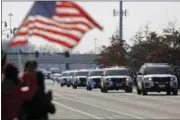  ?? ADAM CAIRNS — THE COLUMBUS DISPATCH VIA AP ?? The police escort Westervill­e Police officers Morelli and Joering home from Franklin County Coroners office Monday in Westervill­e.