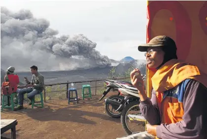  ?? Picture / AP ?? Smoking may be hazardous to your health but, then again, there are surely risks associated with sitting so close to the eruption of Mount Bromo, in Probolingg­o, East Java, Indonesia.