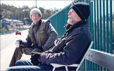  ?? AFP ?? Pontus (left) and Ola Berglund are seen while sitting the first one on the old bridge of Svinesund on May 1.