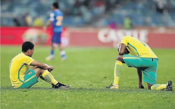  ?? / ANESH DEBIKY/ GALLO IMAGES ?? Dejected Bafana players Keagan Dolly and Ramahlwe Mphahlele reflect after SA’s 2-1 loss to Cape Verde in their World Cup qualifier at the Moses Mabhida Stadium in Durban on Tuesday.