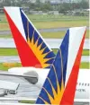  ??  ?? IN THIS file photo taken on Sept. 9, 2014, Philippine Airlines planes taxi at Manila’s internatio­nal airport.