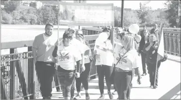  ?? GORDON LAMBIE ?? A small group marched around Sherbrooke's lac des Nations on Saturday morning to raise awareness of the issues of babies born prematurel­y and their families.