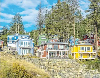  ?? SPIRIT BAY ?? The colourful homes at Spirit Bay are reminiscen­t of a fishing village.