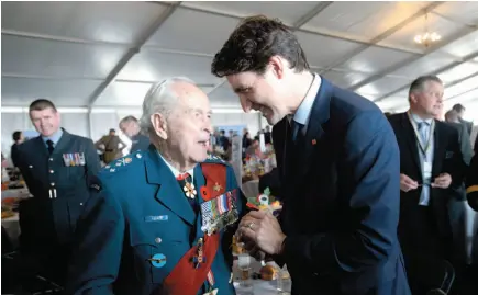  ?? CP PHOTO ?? Canadian Lt.-Gen. Richard Rohmer talks with Prime Minister Justin Trudeau as they take part in the veterans reception as part of the D-Day 75th Anniversar­y British Internatio­nal Commemorat­ive Event at Southsea Common in Portsmouth, England on Wednesday.