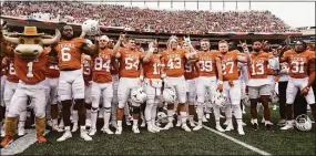  ?? Chuck Burton / Associated Press ?? Texas football players sing “The Eyes Of Texas” after defeating Kansas State on Nov. 26. Texas is one of several states that legally ban using endorsemen­t contracts as pay-for-play or recruiting, but have shown no interest in questionin­g the deals, school officials or third-party groups that set them up.