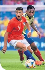  ??  ?? Alfredo Morelos on national duty, up against Chile’s Alexis Sanchez