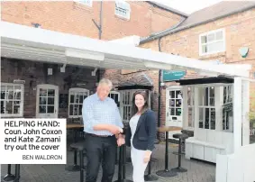  ?? BEN WALDRON ?? HELPING HAND: Coun John Coxon and Kate Zamani try out the cover