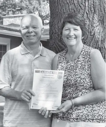  ?? [ALI WILSON / THE OBSERVER] ?? Keith and Sandy Metzger are former award winners themselves, pictured holding their Canada 150 honours.