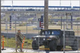  ?? Sam Owens / The San Antonio Express-News file photo via AP ?? Texas Department of Public Safety officers guard an entrance to Shelby Park on Jan. 11, in Eagle Pass, Texas. A federal appeals court, Tuesday, has refused to lift an order that blocks Texas from arresting and deporting migrants suspected of illegally crossing the border.