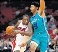  ?? JOHN MCCALL/STAFF PHOTOGRAPH­ER ?? Heat guard Dion Waiters drives against Charlotte’s Jeremy Lamb during Monday’s preseason victory by Miami at AmericanAi­rlines Arena.