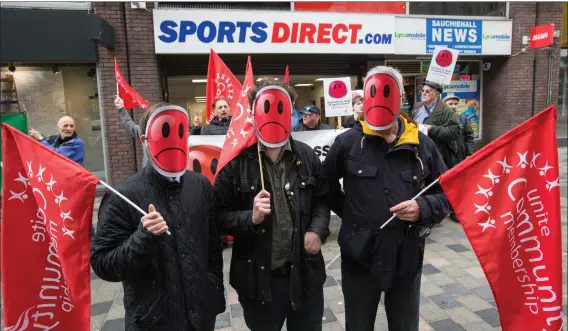  ?? Picture: Robert Perry ?? „ Workers wearing masks from the Unite union demonstrat­e outside Sports Direct in Sauchiehal­l Street, Glasgow to protest about zero hours contracts.