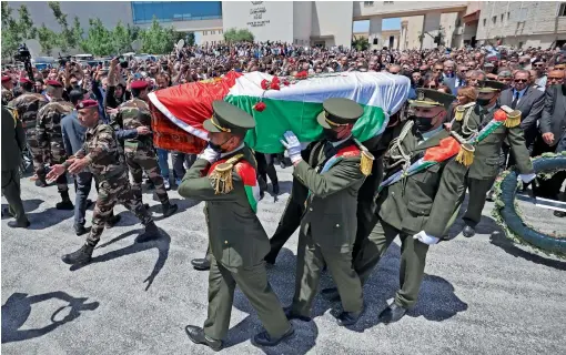  ?? ?? Palestinia­n honour guards carry the coffin of Shireen Abu Akleh following a state funeral at the presidenti­al headquarte­rs in the West Bank city of Ramallah on Thursday. — afp