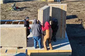  ?? ?? The Lower Sioux constructi­on crew placing a prefabrica­ted hempcrete wall panel, which weighs approximat­ely 700lb. Photograph: Lower Sioux Industrial Hemp Project