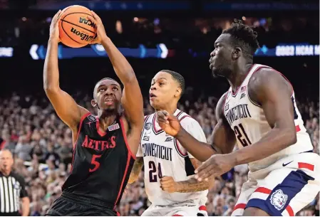  ?? ?? LAMONT BUTLER (izq.), de San Diego State, con la pelota mientras tiene la marca de dos jugadores de Uconn en la final del año anterior