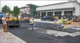  ?? TOM KELLY III — FOR DIGITAL FIRST MEDIA ?? Workers are shown completing blacktop at the new Limerick Fire Company station on Ridge Pike.