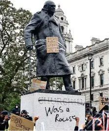  ??  ?? Shocking scenes: The Winston Churchill memorial was defaced in London, while in Bristol a statue of slave trader Edward Colston was pulled down