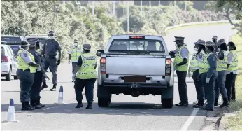  ?? | LEON LESTRADE African News Agency (ANA) ?? METRO police officers at a roadblock earlier this year. A municipal document shows that the city’s metro police and security unit has racked up excessive overtime claims during the lockdown.