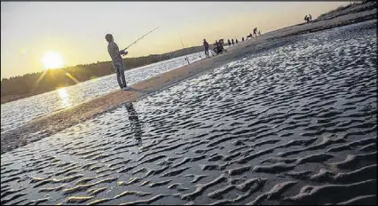  ?? TiM KroChaK/The ChroniCle herald ?? Fishermen try their luck at low tide at McCormacks Beach Provincial Park in Eastern Passage on Tuesday.