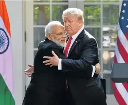  ?? /AFP ?? Strong ties: US President Donald Trump and Indian Prime Minister Narendra Modi embrace in the Rose Garden during a joint media conference at the White House in Washington. Trump urged Modi and his government to do more to relax Indian trade barriers.