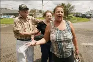  ?? STEVE HELBER — THE ASSOCIATED PRESS ?? Residents of the Spring Meadow subdivisio­n, Debbie Greco, and her parents Fred Carmouche, and his wife Faye, talk to the media after being helped out of their flooded home on a boat after Hurricane Ida moved through Aug. 30in LaPlace, La.