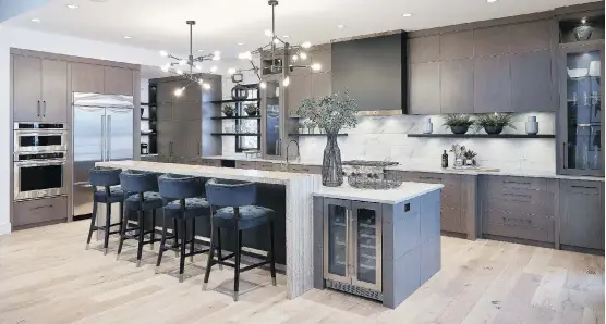  ?? PHOTOS: CALBRIDGE HOMES ?? The kitchen in the Foothills Hospital Home Lottery grand prize has an abundance of storage and a central island nearly 14 feet long.