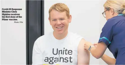  ?? Photo / File ?? Covid-19 Response Minister Chris Hipkins receives his first dose of the Pfizer vaccine.