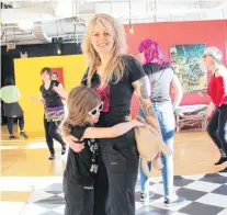  ?? JUANITA MERCER/THE TELEGRAM ?? One of the event organizers, Alison Rideout, takes a break from dancing to pose for a photo with her daughter, Memphis Rideout.