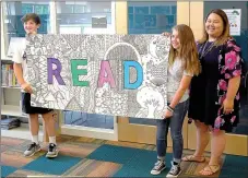 ?? Janelle Jessen/Herald-Leader ?? Sixth-grade Discovery students Ashley Drake and Andrew Pilcher, along with their teacher, Stephanie Harper, presented a portable mural to the Siloam Springs Public Library on Tuesday. Not pictured is Riley Bell, who also helped with the project. The...