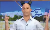  ?? (Screenshot) ?? AN ACTOR IMITATING Education Minister Naftali Bennett sports tefillin boxes, in homage to Israeli Eurovision victor Netta Barzilai’s hairdo.