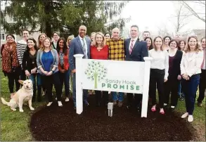  ?? Ned Gerard / Hearst Connecticu­t Media ?? Robert Fuller, right, Assistant Special Agent in Charge of the FBI’s New Haven Field Office and Charles Grady, left, an FBI Community Outreach Specialist, stand with Nicole Hockley, Mark Barden and others from Sandy Hook Promise in Newtown, Conn. April 8, 2019. Sandy Hook Promise were presented with the FBI Director’s Community Leadership Award.