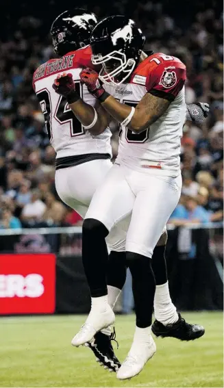  ?? Nathan Denette/the Canadian Press ?? Calgary Stampeders wide receiver Marquay McDaniel, right, celebrates his touchdown catch with teammate Tim Hawthorne, left, during first half CFL football action in Toronto on Friday.