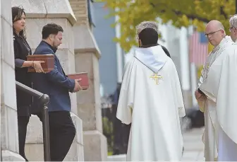  ??  ?? ‘PROMISE OF IMMORTALIT­Y’: The ashes of Dr. Richard Field and Dr. Lina Bolanos are carried out of the Gate of Heaven Church after yesterday’s funeral Mass.