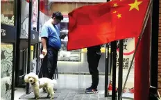  ?? AP PHOTO/NG HAN GUAN/FILE ?? Some Chinese cities are making it illegal to bring your dog into many buildings and on public transporta­tion.