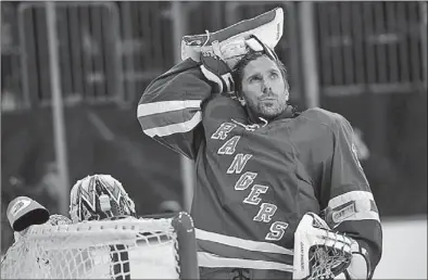  ?? MADDIE MEYER/GETTY IMAGES/AFP ?? Henrik Lundqvist of the New York Rangers looks on before the game against the Florida Panthers at Madison Square Garden on Nov 10 in New York City. The Rangers agreed to a $59.5-million contract extension with Lundqvist on Wednesday.