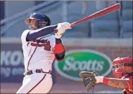  ?? Ap-john Bazemore ?? The Atlanta Braves’ Travis d’arnaud (16) hits a single in 12th inning against the Cincinnati Reds Wednesday in Atlanta.