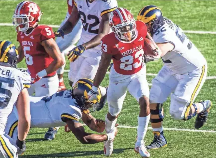  ?? RICH JANZARUK/HERALD-TIMES ?? Indiana’s Jaylin Williams, bottom right, returns an intercepti­on against Michigan Nov. 7 at Memorial Stadium in Bloomingto­n, Ind.