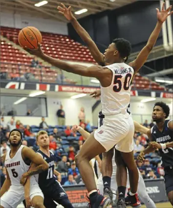  ?? Lake Fong/Post-Gazette ?? Guard Eric Williams Jr., goes up for a basket against Longwood Sunday on his way to scoring 22 points in a 80-71 Dukes win at Palumbo Center.