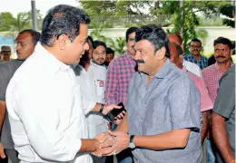  ?? P. SURENDRA ?? Caretaker minister K.T. Rama Rao greets party colleague Talasani Srinivas Yadav at Telangana Bhavan in Hyderabad on Saturday. —